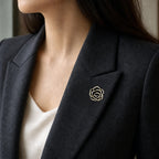 Noir Camellia Brooch worn on a charcoal blazer lapel