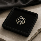 Noir Camellia Brooch arranged in a black velvet and stone still life