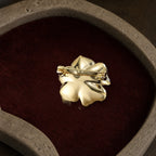 Back view of the Noir Camellia Brooch showing its solid backplate, long pin, hinge and safety clasp