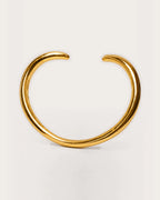 Aalto Gold Heart Cuff Bracelet on a soft warm grey background