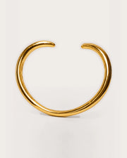 Aalto Gold Heart Cuff Bracelet on a soft warm grey background