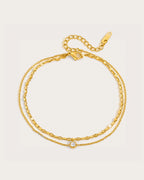 Selene Gold Double-Chain Crystal Anklet on a soft warm grey background
