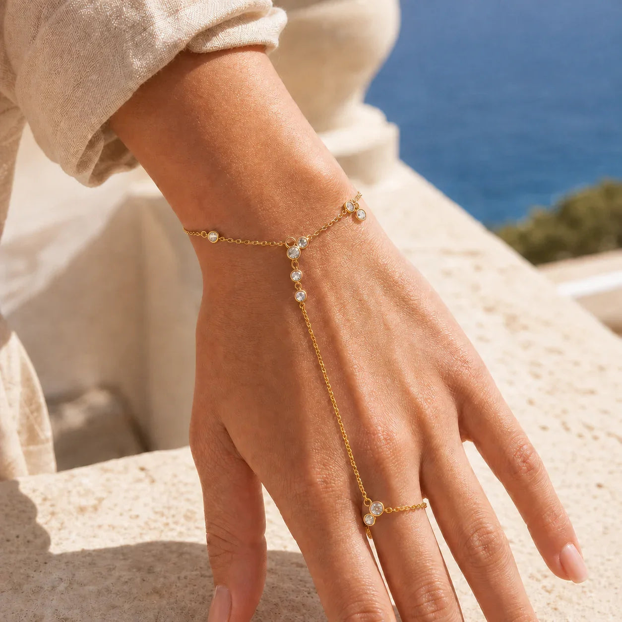 Close view of Siro Crystal Hand Chain worn from wrist to middle finger in polished gold tone