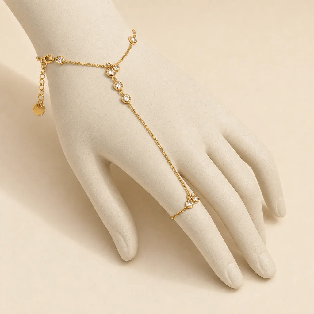 Siro Crystal Hand Chain displayed on an ivory ceramic hand form to show its wrist-to-finger fit