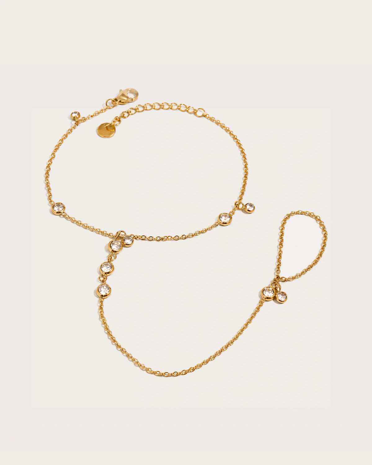 Siro Crystal Hand Chain on a soft warm grey background