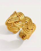 Sola Adjustable Gold Knot Ring on a soft warm grey background