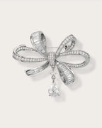 Sylvi Crystal Ribbon Brooch on a soft warm grey background