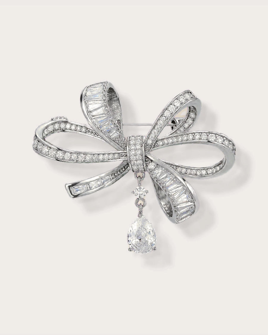Sylvi Crystal Ribbon Brooch on a soft warm grey background