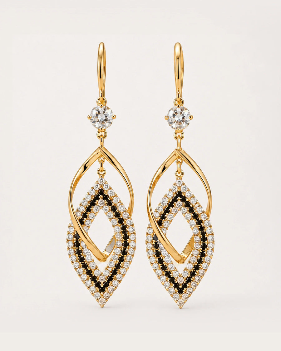 Tähti Crystal Drop Earrings on a soft warm grey background