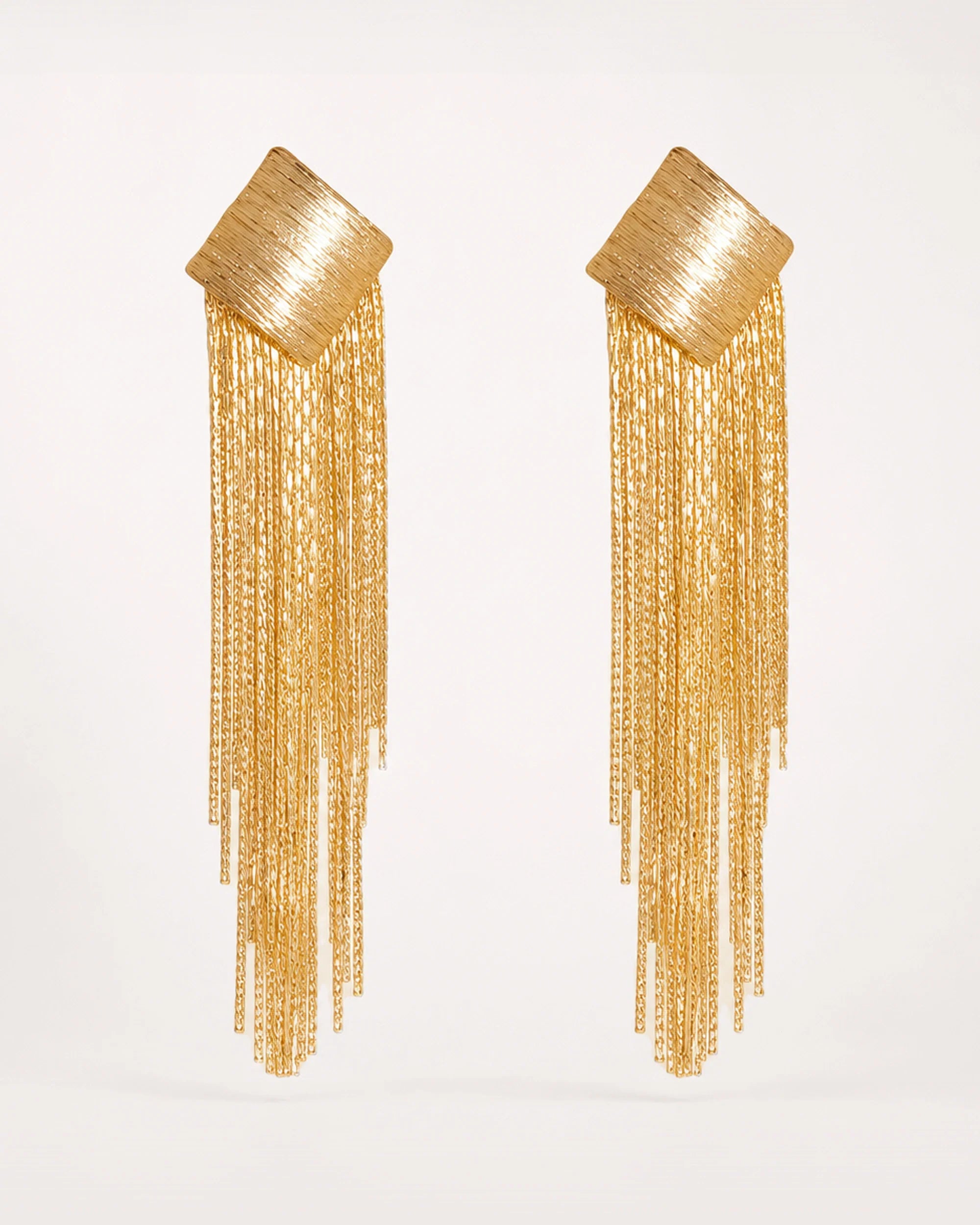 Virta Cascade Gold Earrings on a soft warm grey background