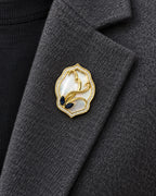 Tuuli Framed Calla Magnetic Brooch, Gold & White worn on a charcoal jacket lapel, close view