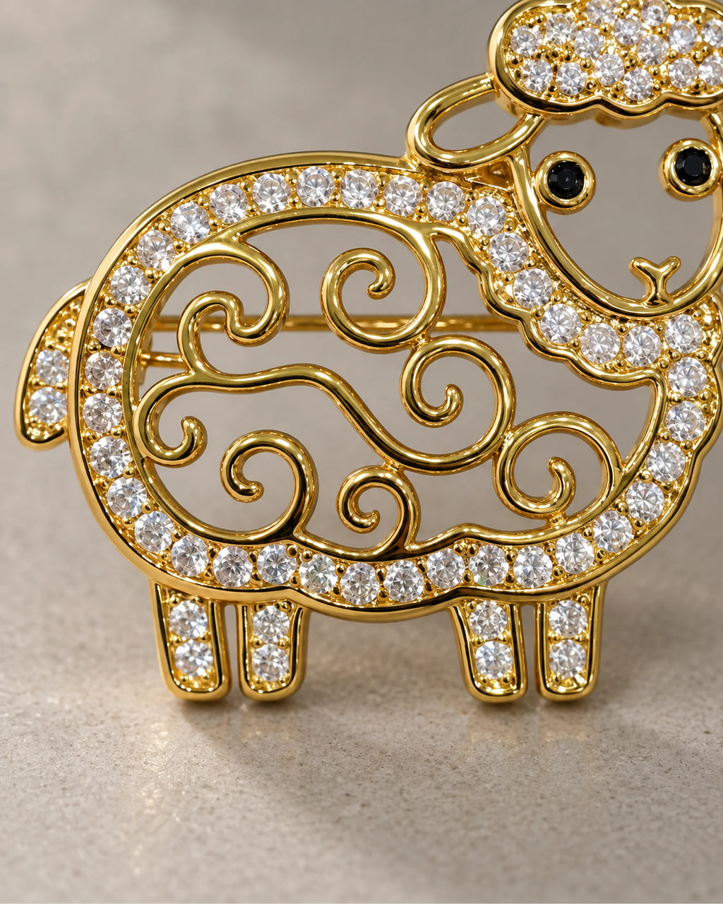 Close-up of open gold curls and clear crystal outline