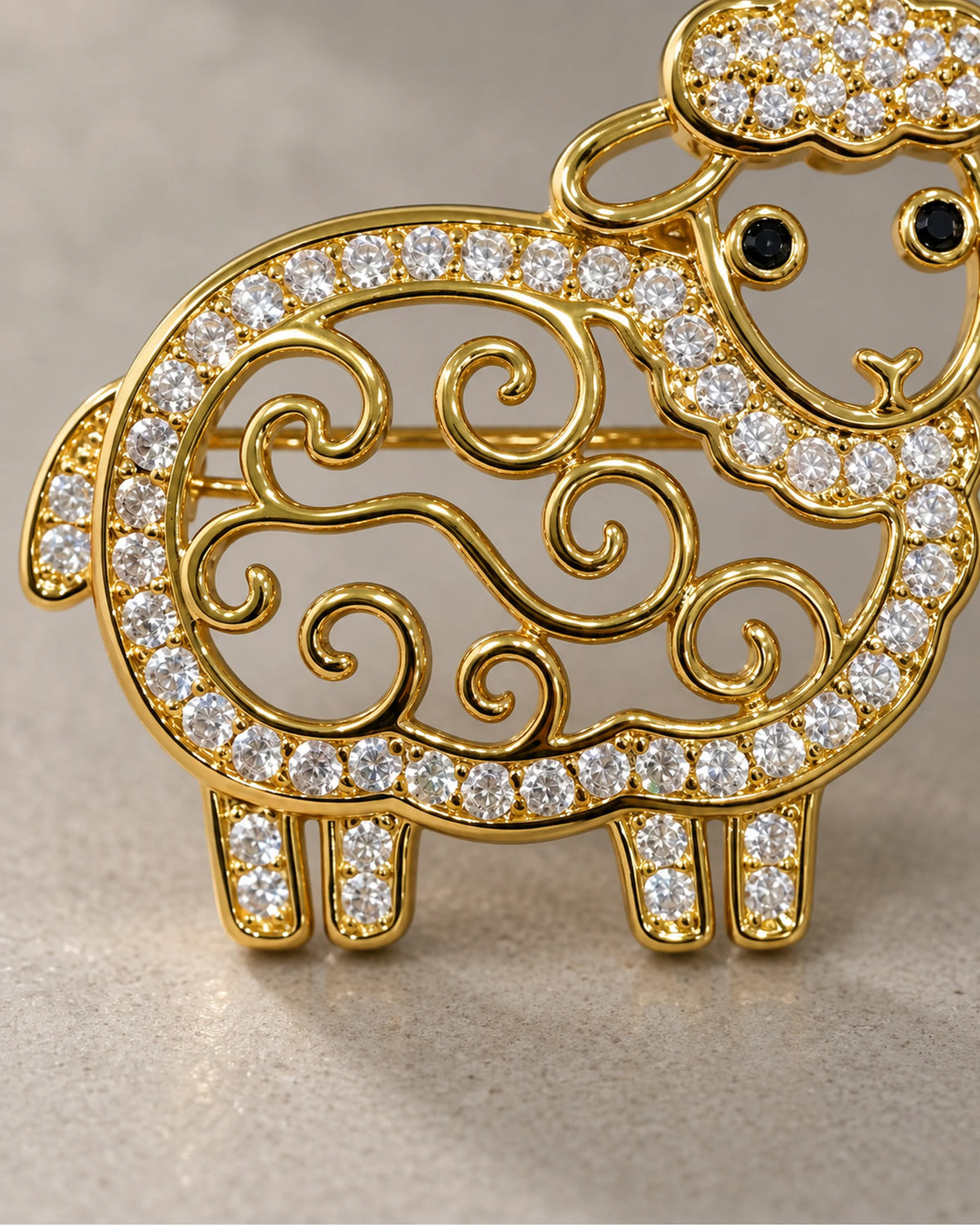 Close-up of open gold curls and clear crystal outline