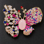The pale-pink oval sits between an open multicolor lattice and densely set clear, pink and blue accents.