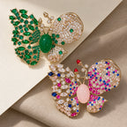 Venla butterfly brooch in Green and Pink, shown as two color choices.