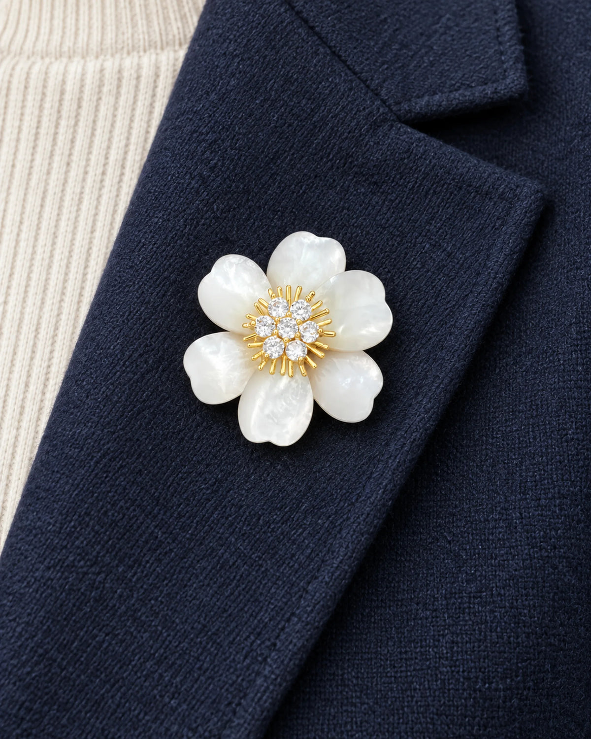 Vieno White Shell Flower Magnetic Brooch, Gold & White worn on a navy jacket lapel, close view