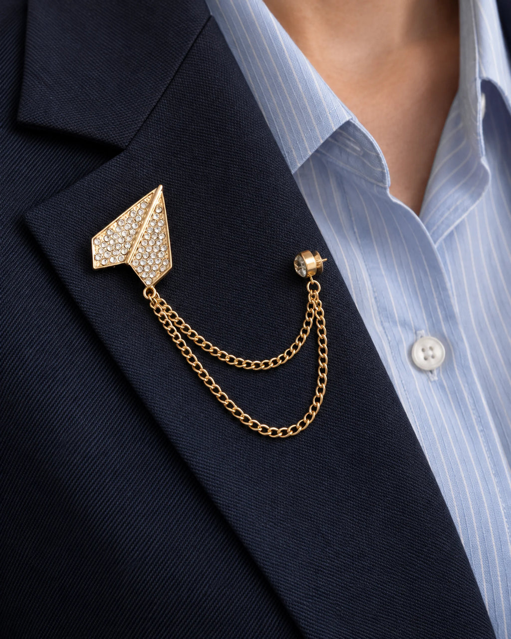 Viesti Paper Plane Lapel Chain Brooch in gold-tone finish; close wearing view on a structured lapel