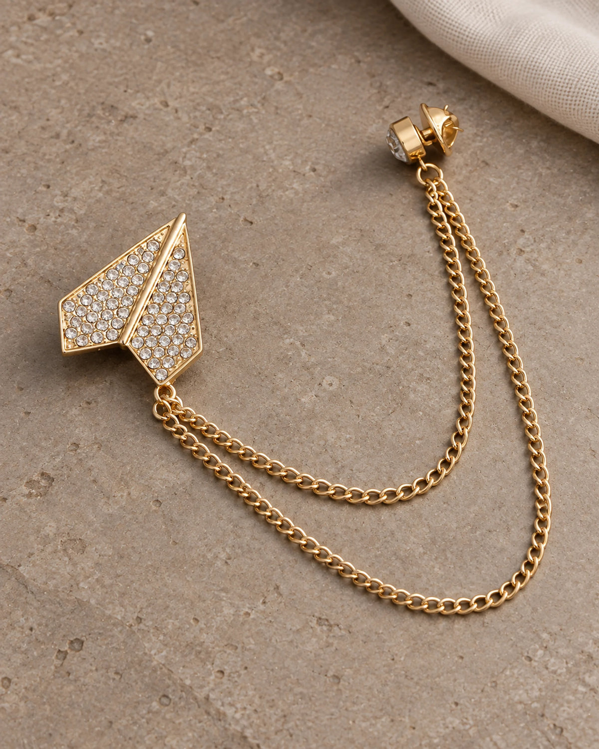 Viesti Paper Plane Lapel Chain Brooch in gold-tone finish; complete still-life drape