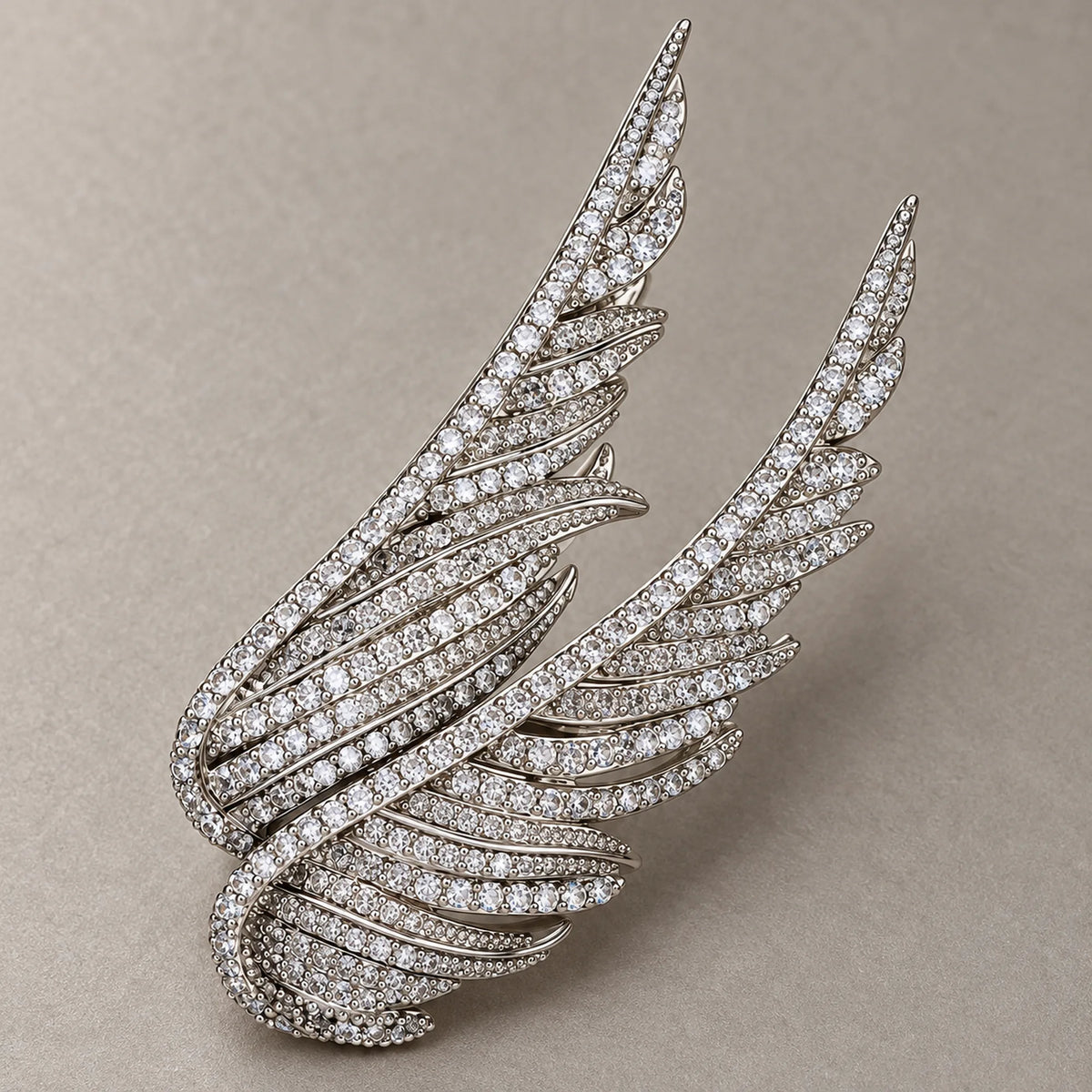 Detail of Silver Vinga showing layered feather-shaped ribs, round zircon accents and open spaces.