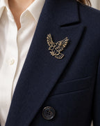 Vinge openwork eagle brooch pinned inside a navy blazer lapel