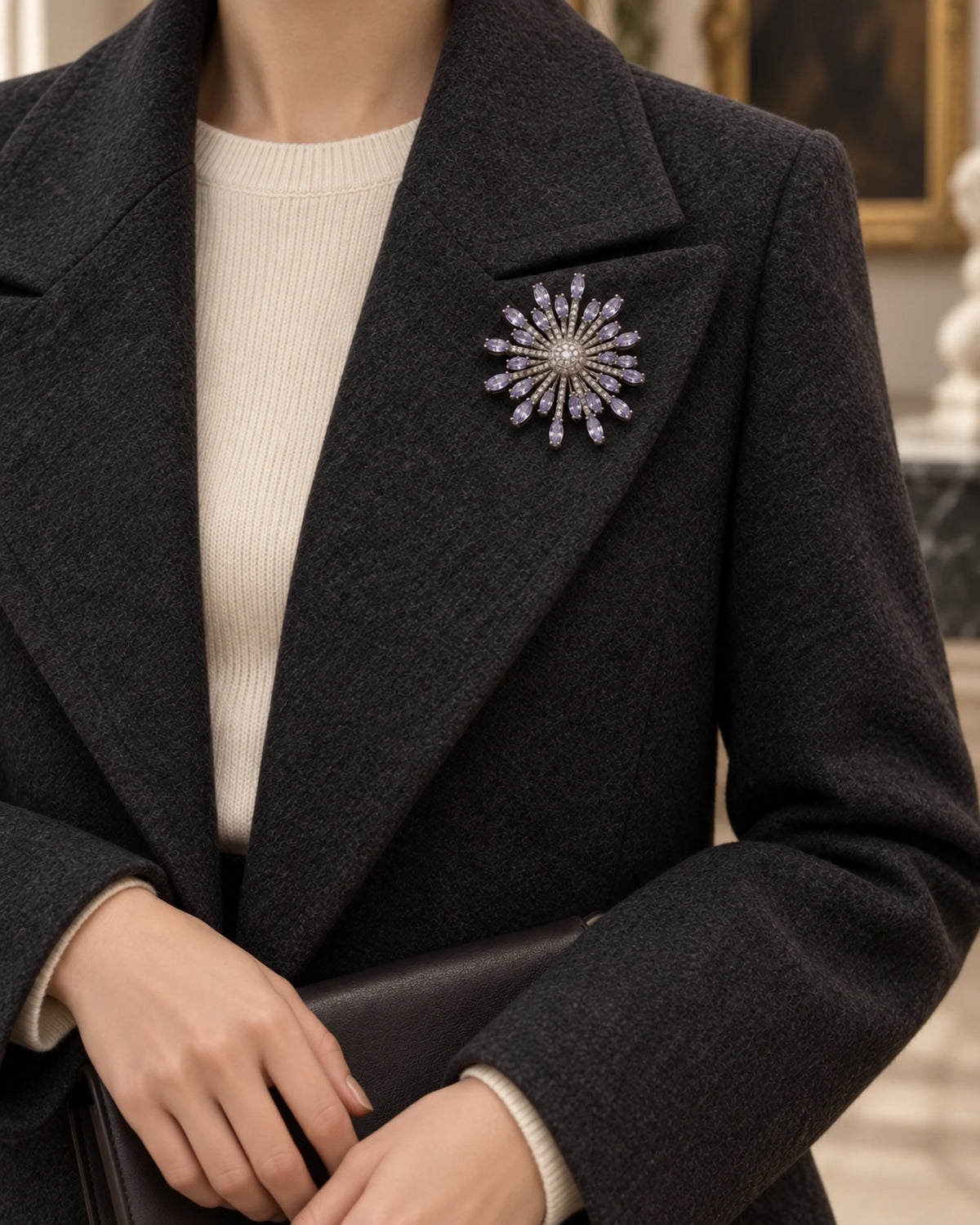 Viola worn on a charcoal coat with a cream knit, wider styling view