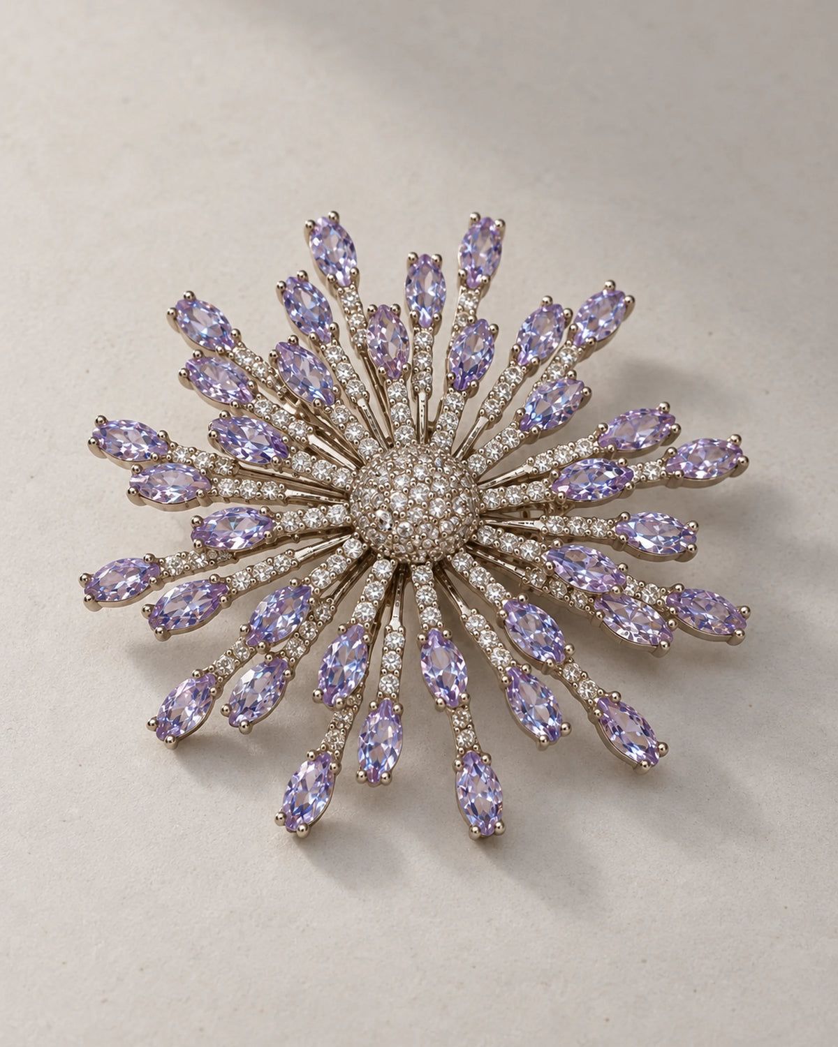 Oblique display of Viola showing staggered silver-tone rays and raised stone tips