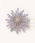 Viola silver-tone lavender zircon starburst brooch on an ivory surface