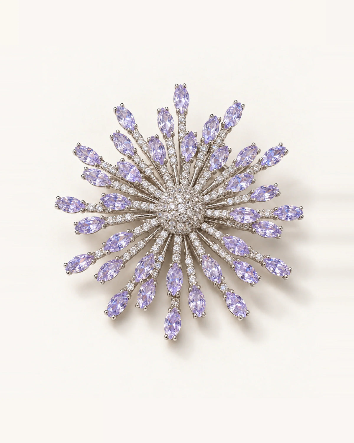 Viola silver-tone lavender zircon starburst brooch on an ivory surface
