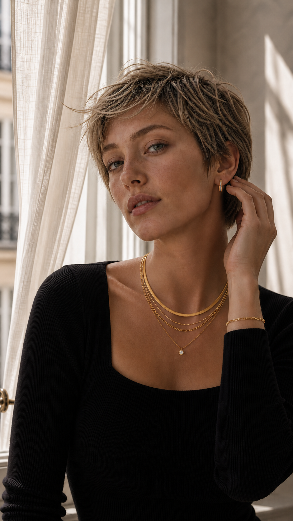 Layered gold chains and coin pendant