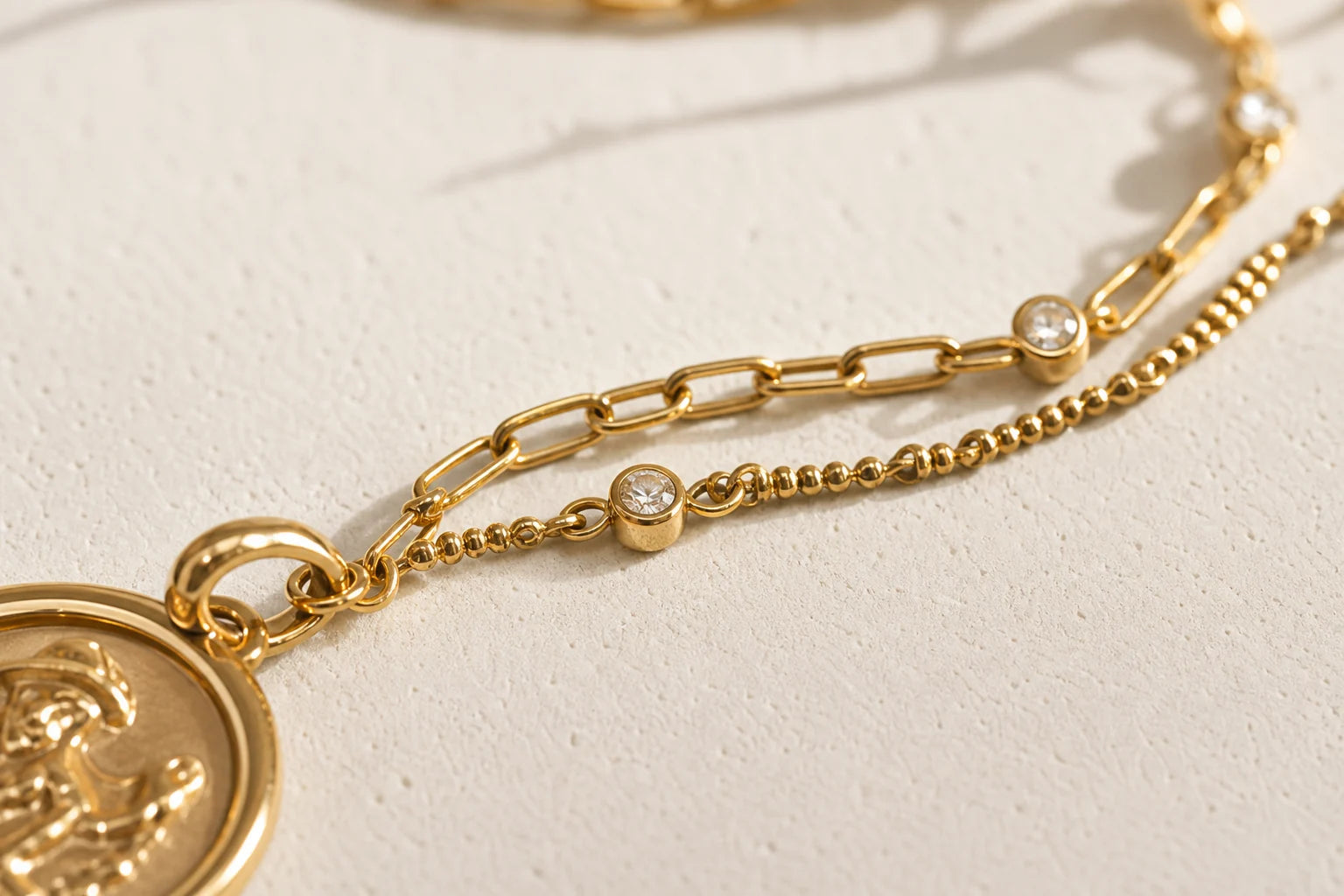 Close-up of gold jewelry links and crystal details