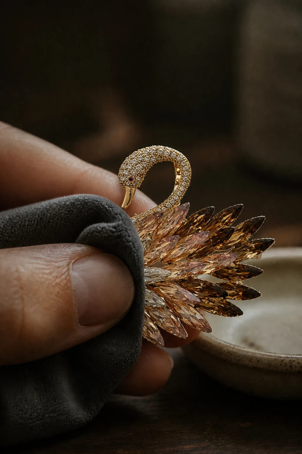 Hand polishing the Odette Gold Crystal Swan Brooch