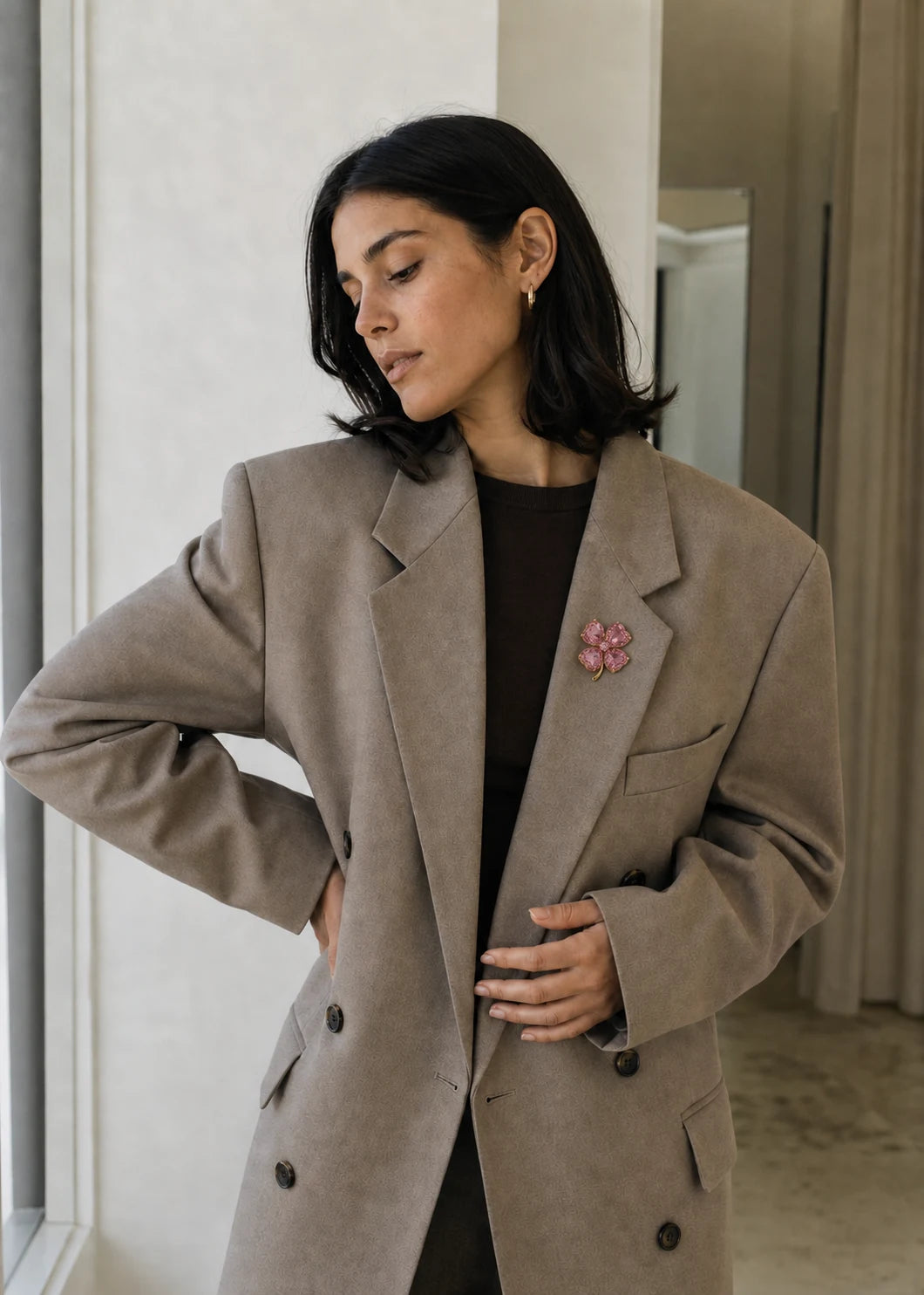 Pink Lykke Clover Brooch worn on soft taupe tailoring
